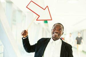 african man pointing with arrow photo