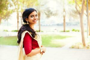 Beautiful indian woman from Kerala wearing traditional clothes photo