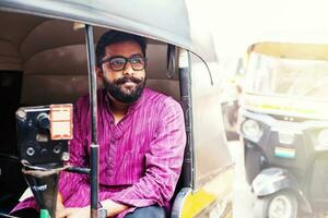 Indian man on a tuk tuk photo