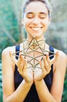 Woman meditating on sacred geometry photo