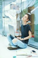 Young modern female worker looking up, thinking, inventing new ideas photo