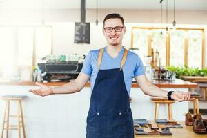 handsome shop owner standing in front of the coffee bar photo