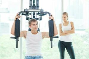 Couple in gym. People working out together photo