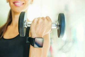 Smart watch showing a heart rate of exercising woman in gym photo