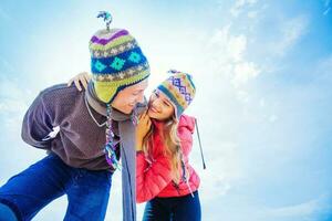 Couple hugging in winter day dressed in woolen hats photo