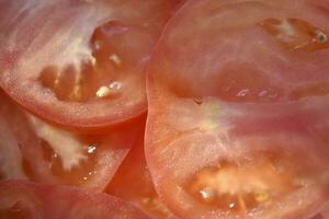 Juicy red tomatoes close-up. Sliced tomatoes into slices. photo