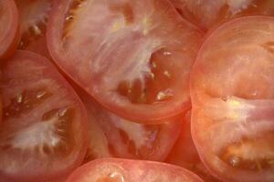 Juicy red tomatoes close-up. Sliced tomatoes into slices. photo