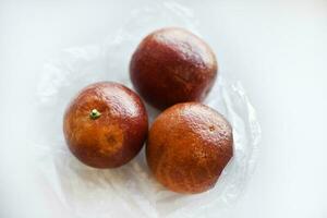 Red oranges on a white background. Juicy fruits. Bright and juicy oranges. photo