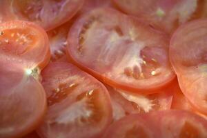 Juicy red tomatoes close-up. Sliced tomatoes into slices. photo