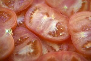 Juicy red tomatoes close-up. Sliced tomatoes into slices. photo