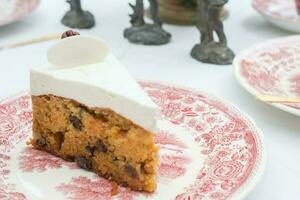 A slice of pumpkin cake on a dish of British vintage style. photo