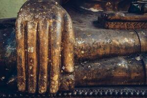 Cropped shot view of the old Buddha statue hand. photo