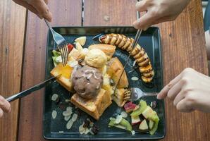 Top view of the Honey Toast, topped with honey, banana and fruits decoration. photo