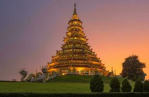 The Chinese pagoda style of Wat Huay Pla Kang in Chiang Rai province of Thailand at dusk. photo