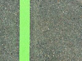 Green lines on asphalt, green paint on asphalt photo