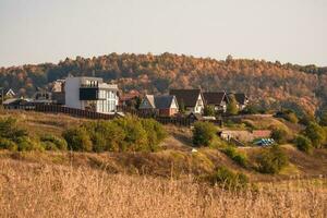 Suburban luxury real estate, modern cottages on a autumn hill. photo