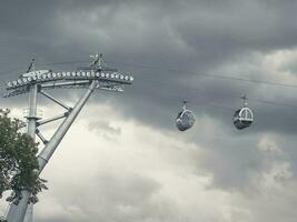 Two cable car cabins side by side against the dark sky photo