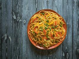 Spaghetti with vegetables on a plate photo