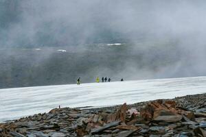 Difficult extreme climb to the top of the mountain. Travel lifestyle, hiking hard track, team work, adventure concept. photo