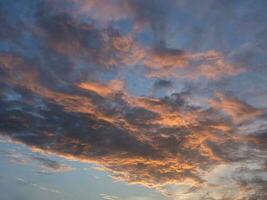 Evening sky with blue, white and orange clouds photo