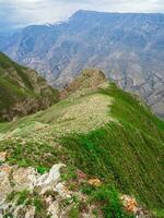 Perspective of rocky ledge. Edge of the cliff, a dangerous gorge. Vertical view. photo