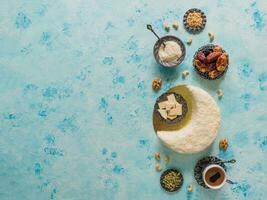 Delicious homemade cake in the shape of a Crescent moon, served with dates and coffee cup photo