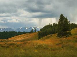 Dramatic sky on mountain peaks. Mystical background with dramatic mountains. Rain in mountains. photo