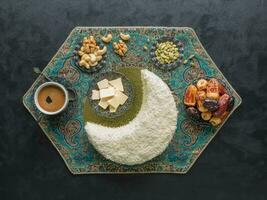 Festive food Ramadan background. Delicious homemade cake in the shape of a Crescent moon, served with dates and coffee cup photo