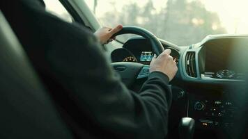 Man drives a car along the road, the setting sun shines in the windshield video