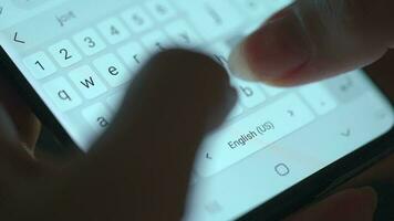 Female hands typing text on smartphone close-up. Using smartphone close up in the evening video