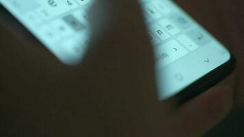 Female hands typing text on smartphone close-up. Using smartphone close up in the evening video