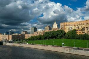 Beautiful Moscow cityscape. Panoramic view of Moscow with beautiful houses on a green hill photo