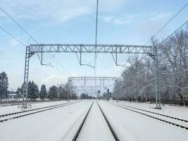 Railway tracks among the white winter snowdrifts, rural railway. photo