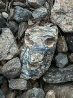 Stone face, a stone shaped like a human face. Mystical spirits of the mountains locked in stone. photo