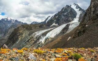 Autumn mountain plateau overlooking the glacier. photo