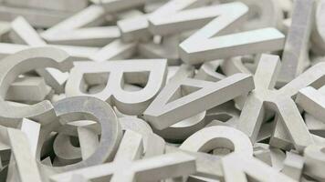 full frame close-up looped slowly rotating background of silver metal letters with selective focus video