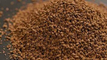 heap of freeze-dried instant coffee granules slow spinning loopable close-up view video