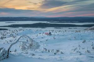 Winter time. Cabins in winter. Dubldom on the mountain Volodyanaya Kandalaksha, Murmansk region in Russia. photo