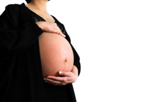 Pregnant woman wearing black dress and holds hands on swollen belly isolated on transparent background and copy space with clipping path. Pregnancy 7-9 months, motherhood, love, expect, care baby. png