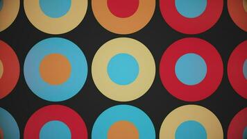 Trendy retro 1970s geometric background with colorful blinking circles in warm color tones - beige, orange, red and blue. This stylish vintage motion background animation is 4K and a seamless loop. video