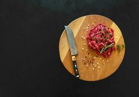 Sliced raw meat on a wooden board. Preparation of beef Stroganoff. photo