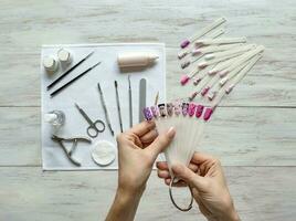 Nail art samples in female hands. photo