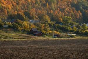 Landscape with farmland ready for planting, with a village on a hill in the background. photo