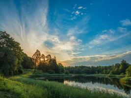 Beautiful summer sunset by the lake. Sky perfect reflection on northern lake photo