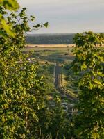 The railway bends in the distance. The railway has a soft focus of field and forest photo