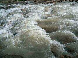 Breakers on the water close up. Powerful stream of water washing away everything. photo