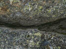 Dangerous fault in the granite rock. Fault line or fracture in the rock, erosion, a crack in the stone. photo