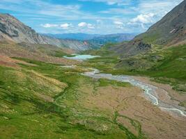 Amazing deep mountain gorge with a shallow riverbed. The bed of the mountain river became shallow after the flow of melt water, the dry season in the mountains. photo