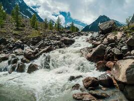 Stormy mountain river with rapids. Beautiful alpine landscape with azure water in fast river. Power majestic nature of highlands. photo