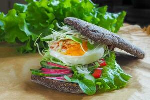 sandwich with egg and lettuce leaves photo